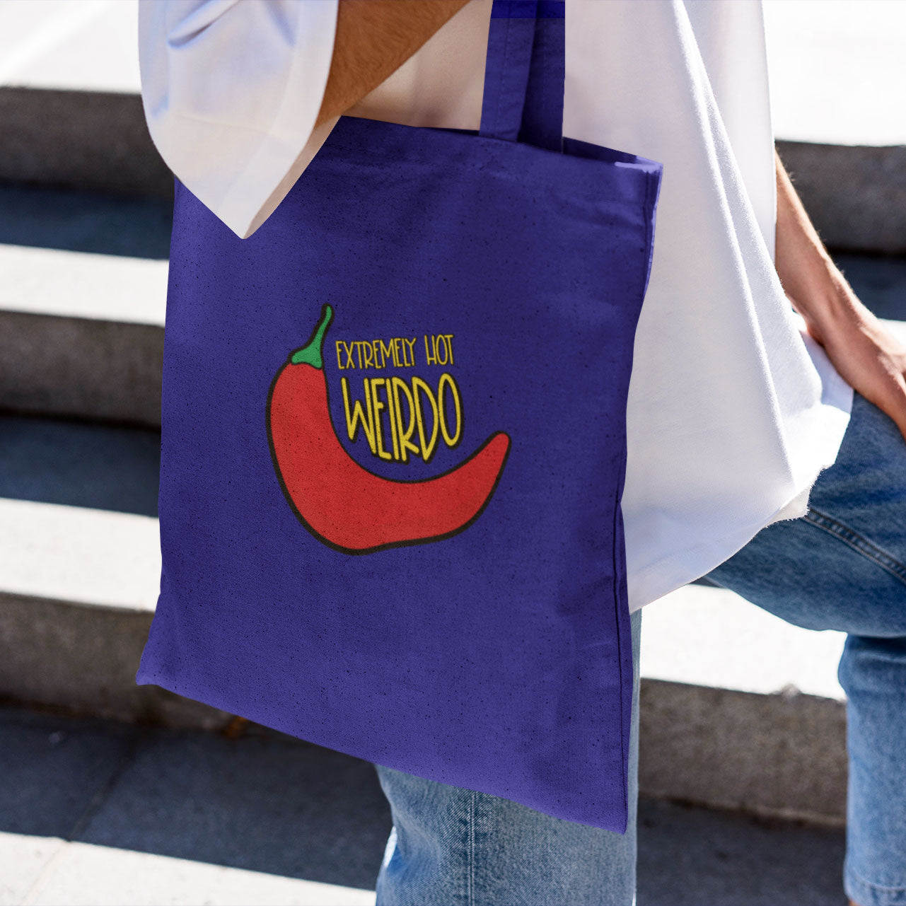 Cotton shopping bag in the color blue with a funny meme printed at the front of the shopping bag: Extremely Hot Weirdo