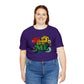 Purple T-shirt with colorful PROUD TO BE ME meme printed at the front of the women’s shirt. Meme is surrounded by colorful flowers.