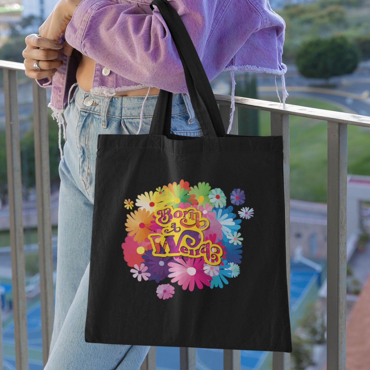 Black cotton tote bag with colorful design with flowers and funny meme: Born a weirdo!