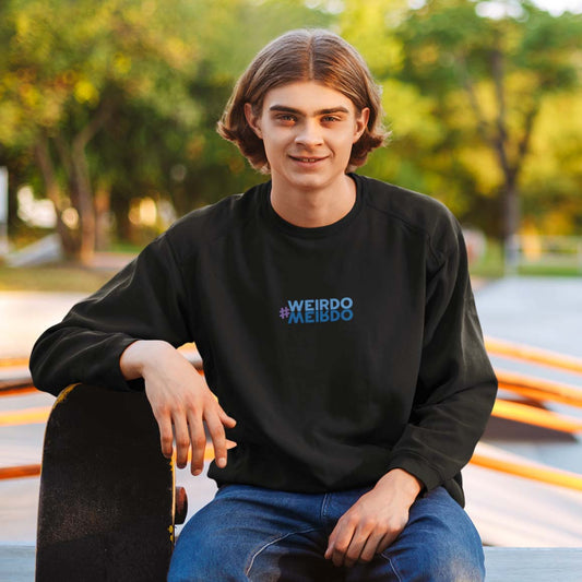 Young man wearing a black sweatshirt with embroidered #WEIRDO meme, mirrored.