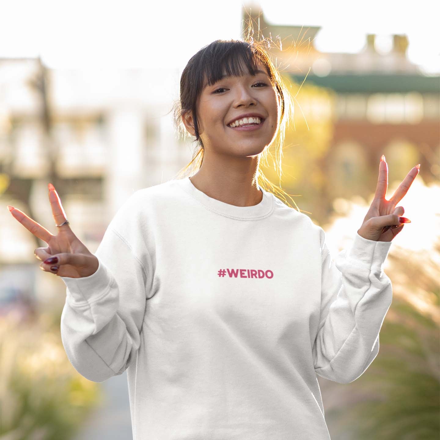 white women's sweatshirt with pink #WEIRDO embroidery